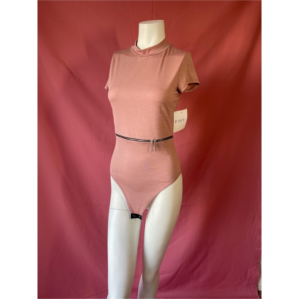 Pink bodysuit with an open zipper on the front waist